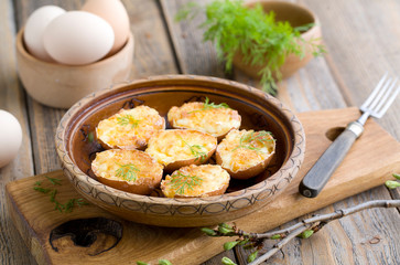 Stuffed eggs in shell fried in a pan.