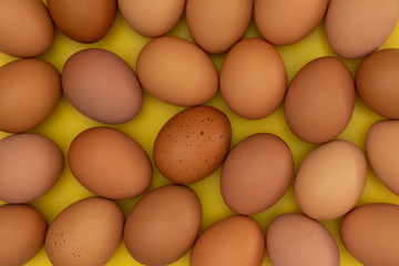 easter eggs laying on a yellow background creating a pattern