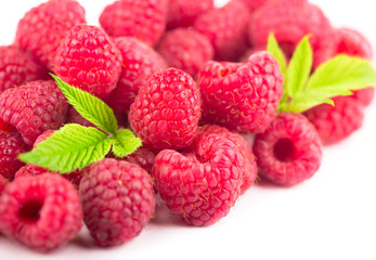 Raspberry with leaves isolated on white background