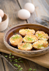 Stuffed eggs in shell fried in a pan.