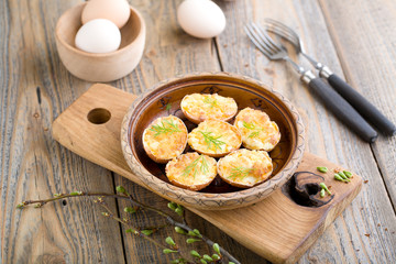 Stuffed eggs in shell fried in a pan.