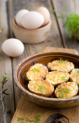 Stuffed eggs in shell fried in a pan.