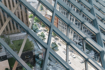 Street view through a metal roof grid