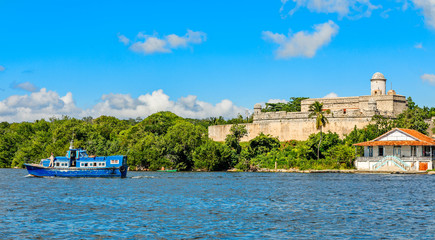 Jagua castle fortified walls with trees and fishing boats in the foreground, Cienfuegos province,...