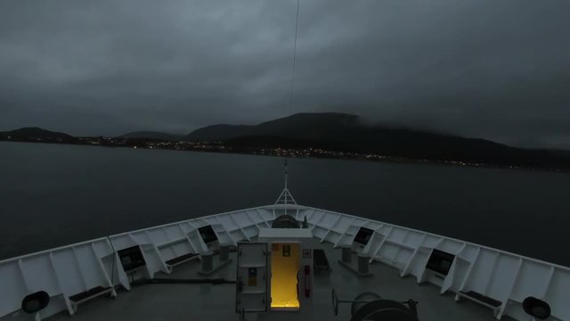 Stokmarknes Departure.  A timelapse recording looking over the bow of a ship as it departs the town of Stokmarknes, Norway.