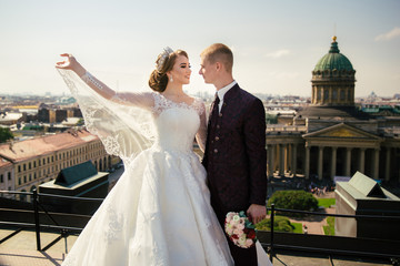 Bride and Groom on Wedding Day in city on roof in St. Petersburg.