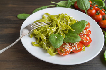 spinach tagliatelle with cherry tomatoes. proper diet.