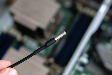 Naklejka premium temperature sensor at circuit board background. sensor to controll temperature at server room.