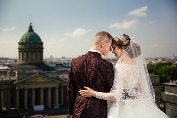 Bride and Groom on Wedding Day in city on roof in St. Petersburg.