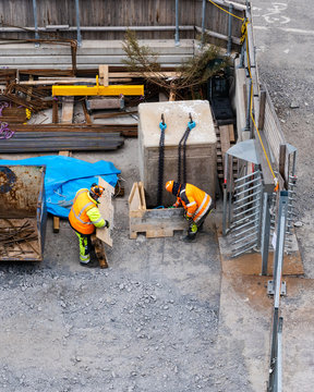Two construction workers at the sites storage area searching for material, Stockholm Sweden