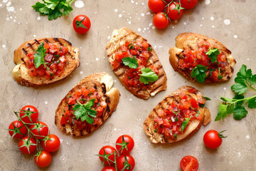 Toasts with cherry tomatoes, red onion and olive oil.Top view with copy space.