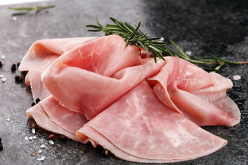 Sliced ham on wooden background. Fresh prosciutto cotto. Pork ham sliced.