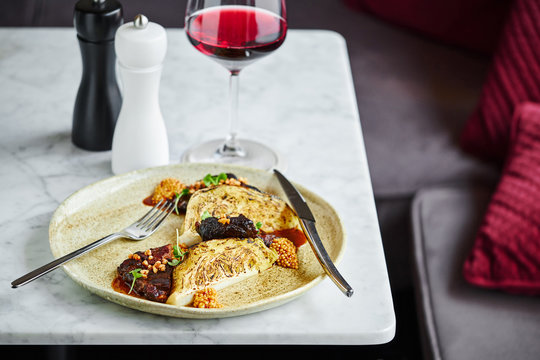 Gourmet pork cheek dish with baked celery root and french mustard