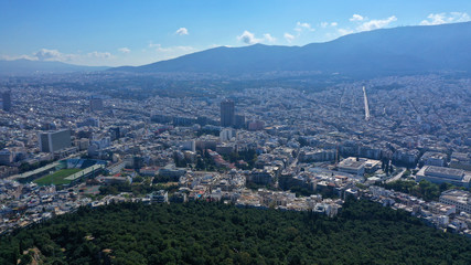 Fototapeta na wymiar Aerial drone panoramic photo of iconic Saint George Lycabettus chapel as seen from top of hill, all Athens cityscape and Acropolis hill at the background, Athens historic centre, Attica, Greece