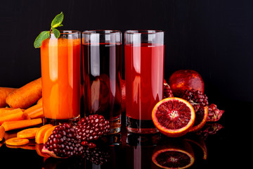 Different healthy vegan drinks on the black background. Raw drinks and foods.