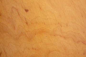 The wooden background is light brown with stripes .