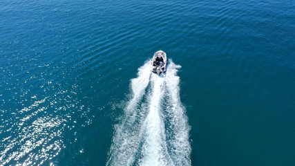 Aerial top view of speed boat cruising in mediterranean open sea
