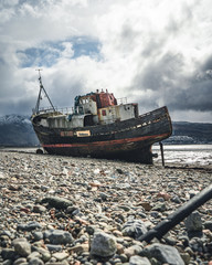  View of Abandoned vintage fishing boat on beach near Corpach village, Fort William, Scotland,...
