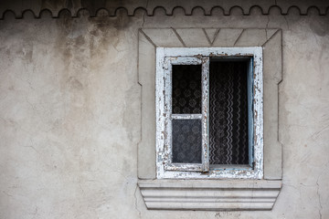 Window and wall of old abandoned house.