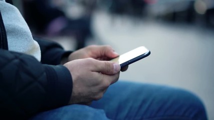 Close-up View of Man Using Smartphone in the city street