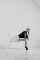 Young beautiful woman with dyed blue and green hair. Pixie bob short haircut The concept of hair styling.