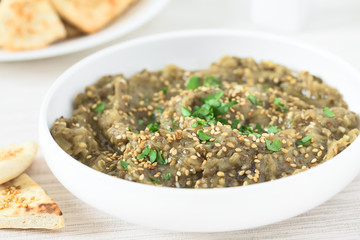 Homemade roasted eggplant dip or spread, baba ganoush in the Mediterranean cuisine, with olive oil,...