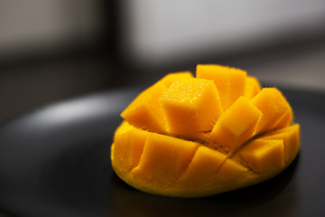 Close-up of mango fruit on black background.