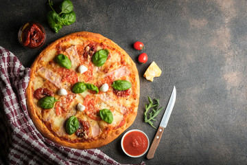 Traditional Italian pizza on a dark background top view copy space.