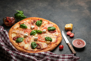 Traditional Italian pizza on a dark background copy space.