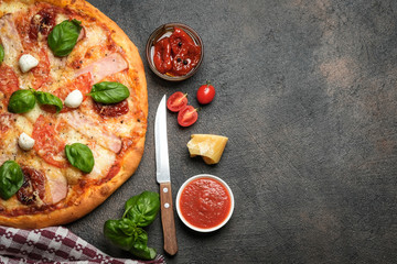 Traditional Italian pizza on a dark background top view copy space.