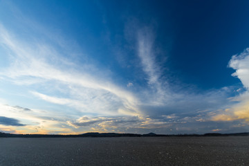 Sunset sky with nice clouds over spring fields