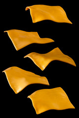 Yellow Cheese Slices Isolated On Black