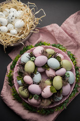 Easter eggs wreath and decorations on the table, spring