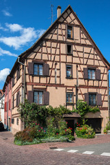 Fototapeta na wymiar Beautiful half-timbered houses with red tiled roofs in the historic center of Selestat in Alsace.