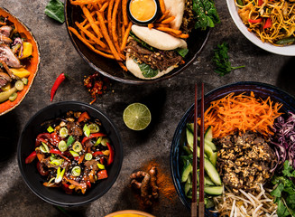 Asian food background with various ingredients on rustic stone background , top view.