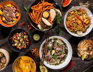 Asian food background with various ingredients on rustic stone background , top view.
