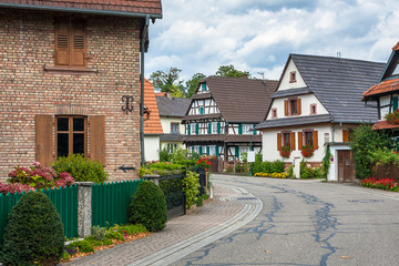 Fototapeta na wymiar Traditional half-timbered houses in the streets of the small town of Seebach in Alsace
