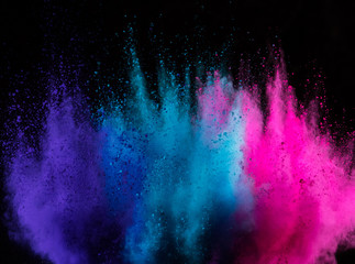 Colored powder explosion on black background.