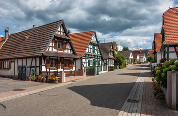 Fototapeta na wymiar Traditional half-timbered houses in the streets of the small town of Seebach in Alsace