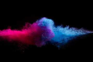 Colored powder explosion on black background.