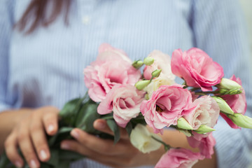 Obraz na płótnie Canvas Female florist making beautiful bouquet at flower shop