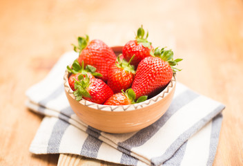 Fresh strawberries on ceramic bowl 
