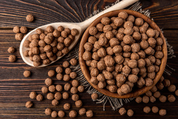 Chocolate dried balls on dark wooden background. 