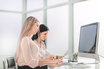 two employees sitting at the office Desk.