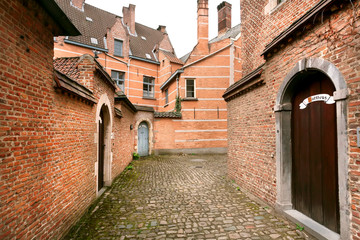 Fototapeta na wymiar Old narrow street at historical Beguinage, 13th century complex houses for beguines women