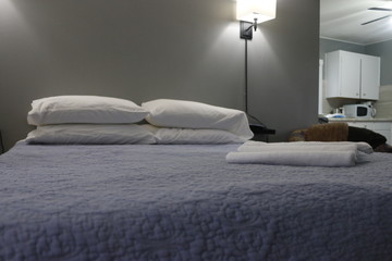 Clean towel on bed in modern interior bedroom