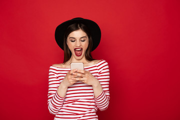 Happy excited girl messaging at mobile phone