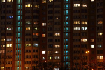 Fototapeta na wymiar Lights multi-storey building in the twilight - texture for background
