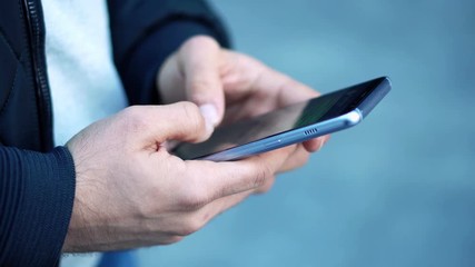 Close-up View of Man Using Smartphone in the city street