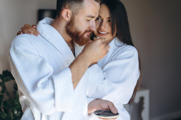 Happy couple enjoy each other's company in a hotel room.